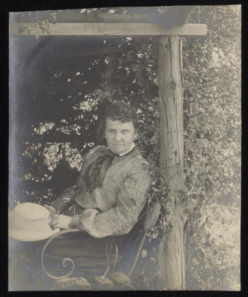 Susanne Gether sitting in a garden chair, approximately 1896