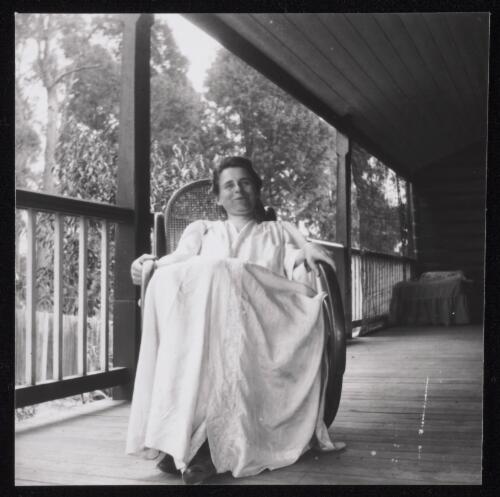 A woman sitting in a rocking chair on verandah, Sydney?, approximately 1905