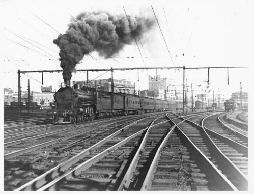[Locomotive A2 910 on Down Albury Express, leaving Spencer Street Station, Melbourne, Victoria, 1934] [picture] / John L. Buckland
