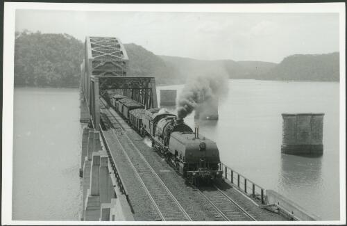 [A Garrat Locomotive 6015 crossing the new Hawkesbury River bridge, New South Wales, with an up (south bound) train, the piers of the old bridge are in the background] [picture] G. A. Grant