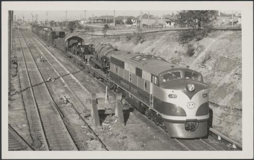 Commonwealth Railways locomotive GM11 hauling freight train, including L class locomotive, leaving Enfield [picture]