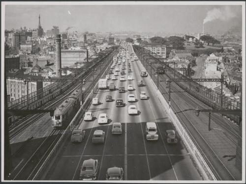 Early morning traffic streams over Sydney Harbour Bridge towards the city along the Bradfield Highway (named after the bridge architect, Dr J.J.C.Bradfield), looking south with electric train and trams [picture] / John Tanner