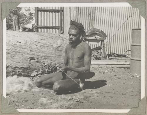 Peter Wira, a Pitjantjatjara man, twisting and spooling woollen cord, South Australia, ca. 1946, 5 [picture]