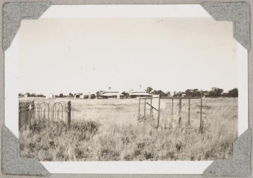 Graves of Tom Nugent, on left, and Archibald Cameron, right, with the old telegraph station in the background, Tennant Creek, Northern Territory, ca. 1946 [picture]