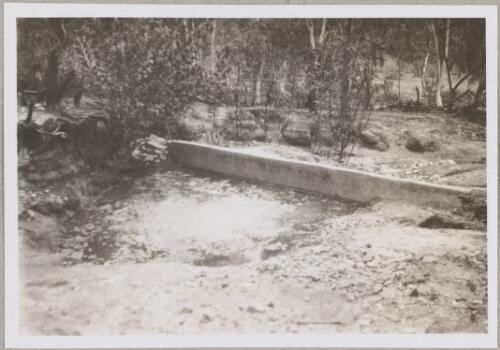 Small concrete dam across a creek at an unidentified location, Northern Territory, 1950? [picture]