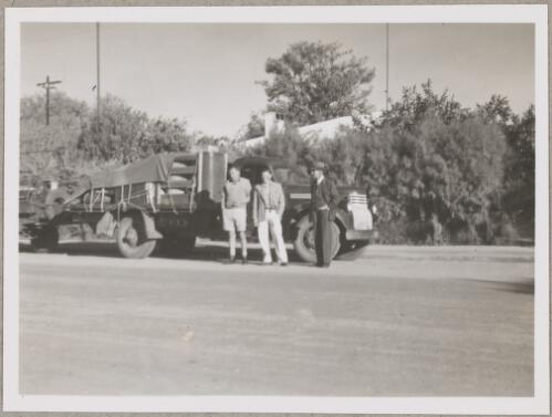 Bob Gregory, left, D. D. Smith, centre, and Roy Vyse, right, standing in front of a truck at the corner of Parsons and Hartley Streets, Alice Springs, 1949 [picture]
