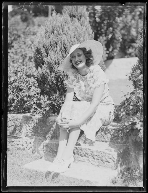 Model Margaret Vyner sitting in a garden wearing a hat, New South Wales, 21 March 1934 [picture]