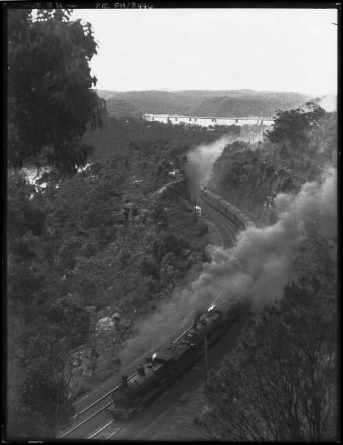 Train coming up grade, bridge in far background [New South Wales] [picture] / [Frank Hurley]