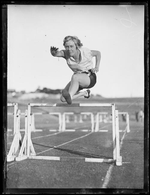 Australian athlete Clarice Kennedy jumping over a hurdle, New South Wales, ca. 1932 [picture]