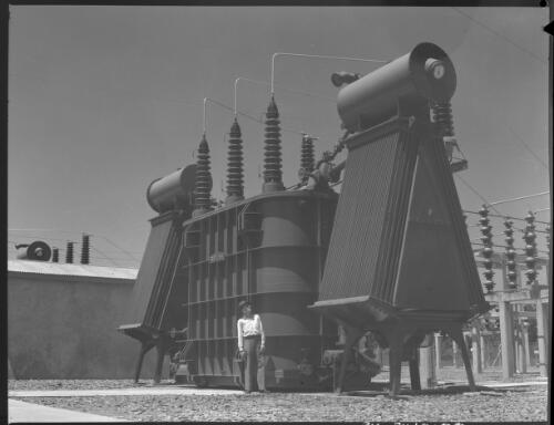 [Man standing in front of Power station, Queensland, 2] [picture] / [Frank Hurley]