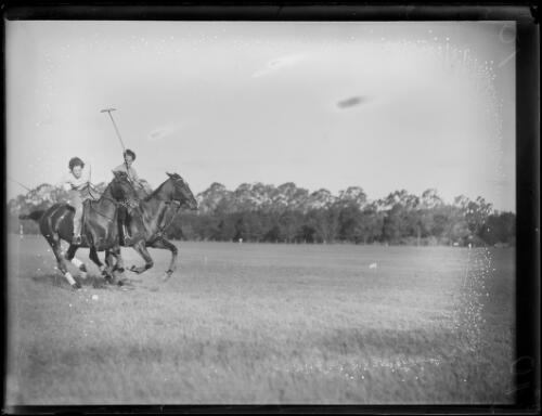 Two polo players on ponies, one player about to hit ball, Cobbitty, New South Wales, 23 April 1934 [picture]