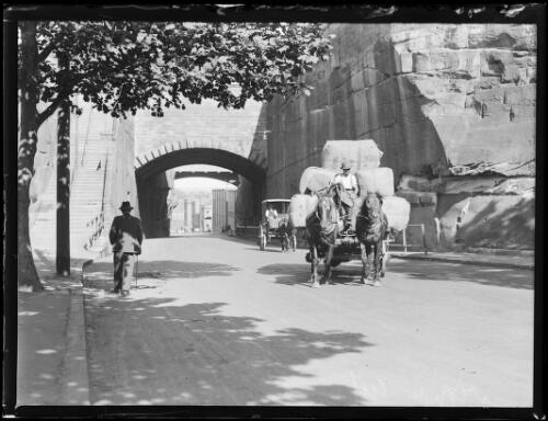 Horsedrawn wagon, followed by a cart, exiting the Argyle Cut, The Rocks, Sydney, ca. 1920s [picture]