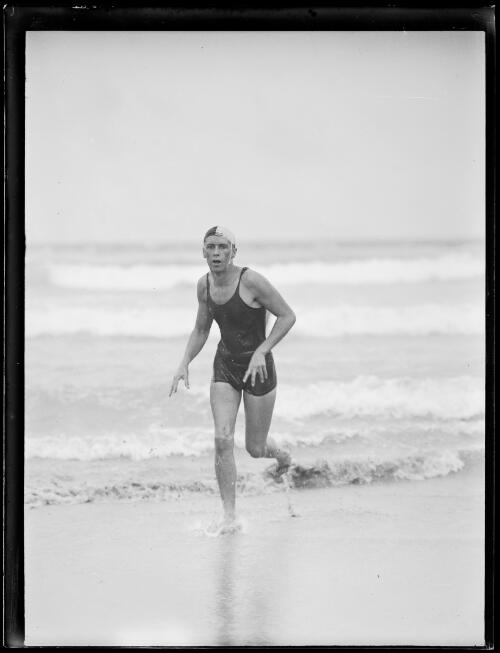 Swimming champion Asher Hart running out of the ocean in a nipper costume, New South Wales, ca. 1930s [picture]