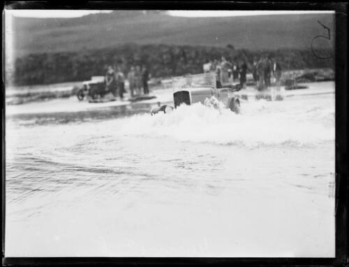 Flood waters submerging a race car at the Gerringong Motor Races, New South Wales, 10 May 1930 [picture]