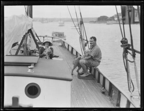 Engineer and aviator Lee K. Murray and his wife with their cat and a dog, onboard the yacht Day Dream, Sydney Harbour, 2 December 1931 [picture]