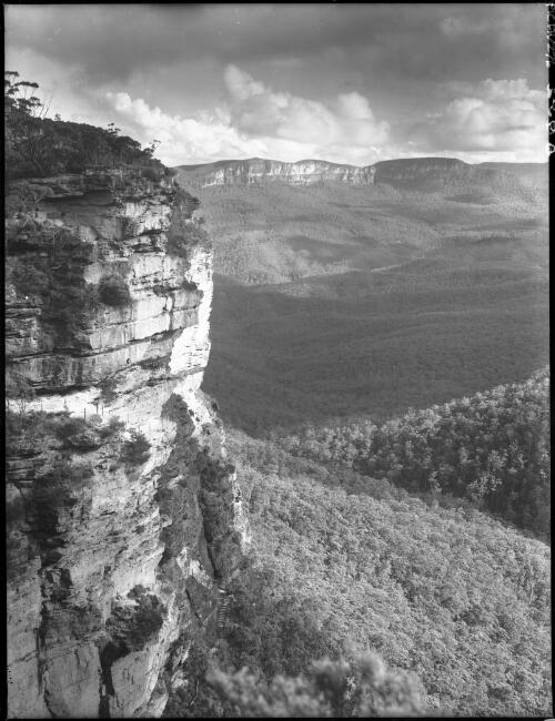Jameson valley cloud shadows & big cliff face [picture] : [Blue Mountains, New South Wales] / [Frank Hurley]