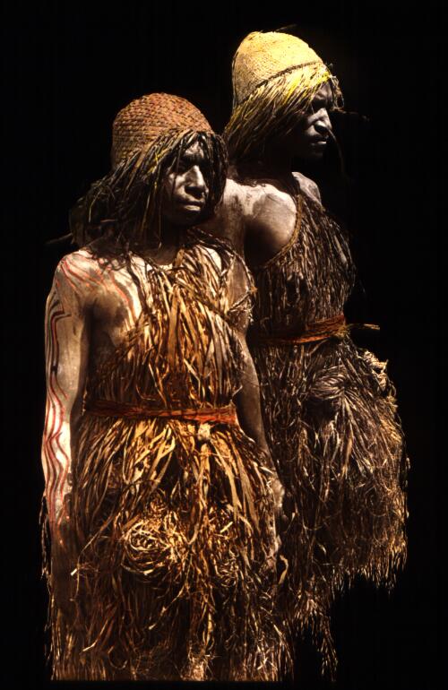 [Two widows of Aduru, clad in river mud and grass skirts of mourning] [picture] : [Papua] / [Frank Hurley]