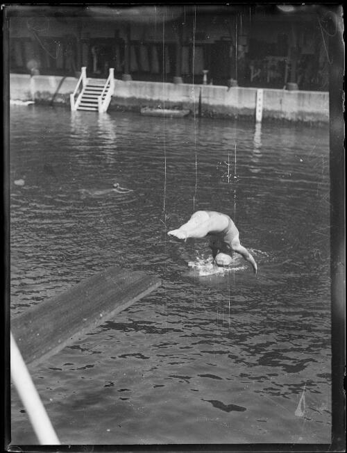 Diver Lurline Hook diving backwards off a diving board into the water, New South Wales, ca. 1930s [picture]