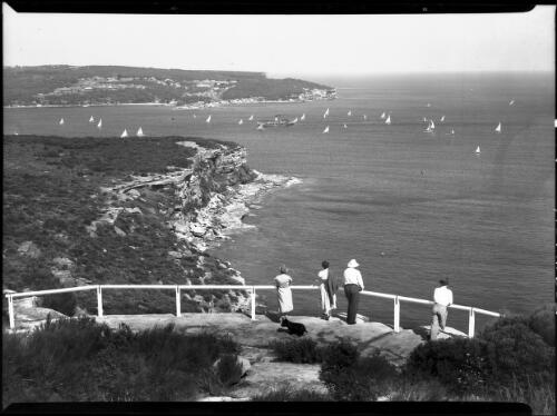 Scene looking to heads from Dobroyd Lookout ferry, small yachts, people, a dog, two headlands, Sydney Harbour [picture] / Frank Hurley
