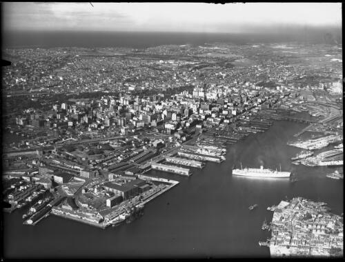 High shot wharfing area from above Pyrmont white ship in FG [picture] : [Sydney, New South Wales, Aerial] / [Frank Hurley]