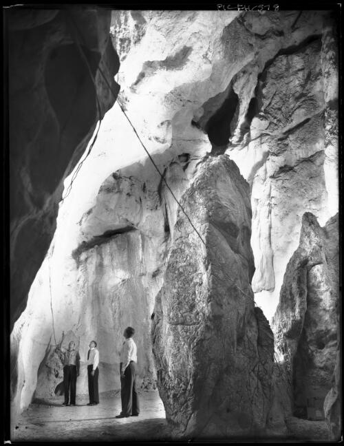 Olsen's Caves, Rockhampton [with three figures] [picture] : [Rockhampton, Queensland] / [Frank Hurley]