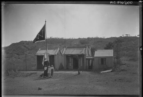 [Three women near three small buildings with Chinese writing and flag] [picture] : [Darwin, Northern Territory] / [Frank Hurley]