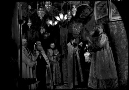 Armenian priests at prayer before the Altar of the Nativity, the Chapel of the Nativity [Jerusalem] [picture] / [Frank Hurley]