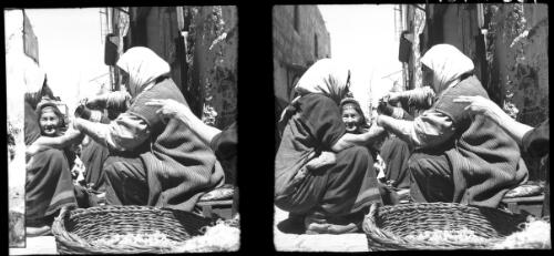 Street sellers in David St., Jerusalem [squatting figures with basket and jug] [picture] / [Frank Hurley]