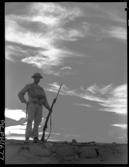 [Soldier with rifle and bayonet standing on a wall] [picture] : [World War I] / [Frank Hurley]