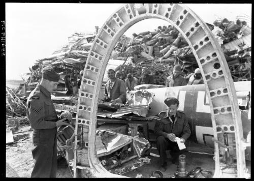 [Salvage dump, air crew, an arch] [picture] / [Frank Hurley]