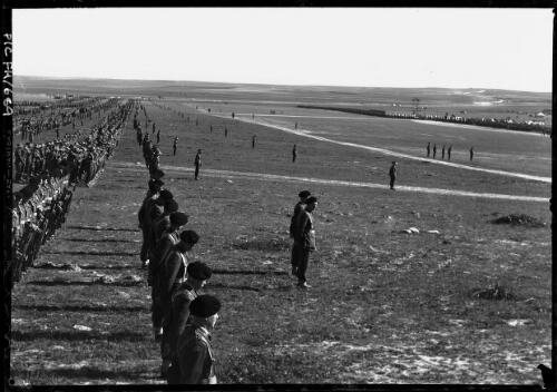 [Panorama of rows of assembled men in military uniform in a field, and truck with cross] [picture] / [Frank Hurley]