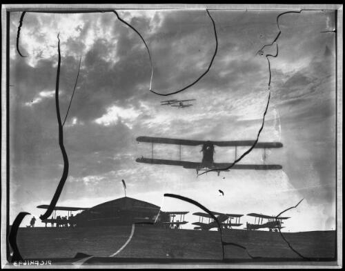 [The First Australian Flying Corps in the air over Palestine and in descent, several aeroplanes on the ground and three in the air, 16 February 1918] [picture]  / [Frank Hurley]