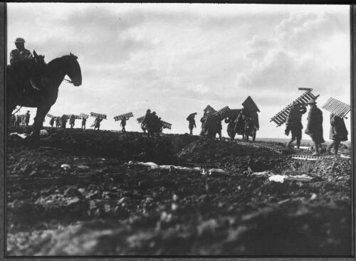 [Soldiers carrying duckboards, soldiers on horseback, near Zonnebeke, Flanders, October 1917] [picture] : [Flanders, World War I] / [Frank Hurley]