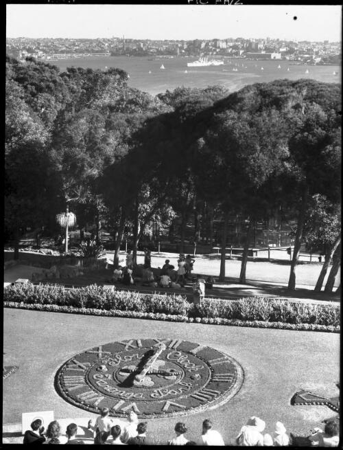 Floral clock, city in background, 2 [picture] : [Taronga Park Zoo, Sydney, New South Wales] / [Frank Hurley]