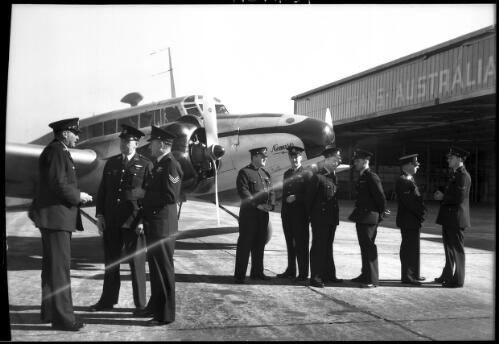 [The Aviation Section of the New South Wales police Force, aircraft Nemesis and nine men in uniform, 2] [picture] : [Sydney, New South Wales] / [Frank Hurley]