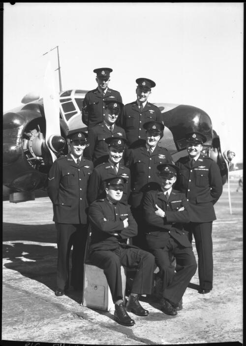 [The Aviation Section of the New South Wales Police Force, aircraft Nemesis and nine men in uniform, 1] [picture] : [Sydney, New South Wales] / [Frank Hurley]