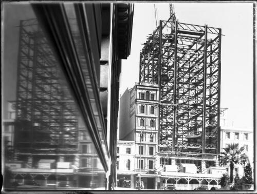 [Steel frame of AWA building and old building, Mangovite Belting Ltd., with reflections, Sydney] [picture] : [Sydney buildings, New South Wales] / [Frank Hurley]