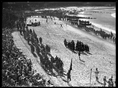 March past, up & down beach [Grand Parade of surf life savers, Surf Carnival, Manly Beach, 1940s] [picture] : [Sydney, New South Wales] / [Frank Hurley]