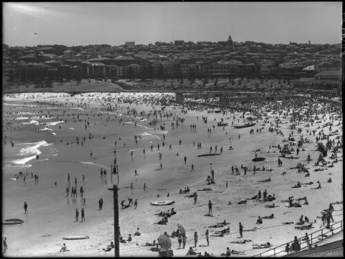 [Bondi Beach looking south west showing two groynes destroyed in January 1942, Bondi Pavilion] [picture] : [Beaches, Sydney, New South Wales] / [Frank Hurley]