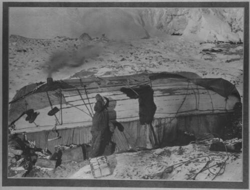 The Snuggery where the twenty-two marooned men lived packed like sardines [with two upturned boats, the Dudley Docker and the Stancomb Wills, on Elephant Island, Shackleton expedition, 1916] [picture] : [Antarctica] / [Frank Hurley]