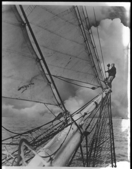 [Frank Hurley photographing from the tip of the jib-boom of the Discovery, Banzare, 1929-1931] [picture] : [Antarctica] / [Frank Hurley]