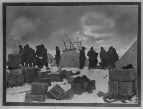 Dump Camp, the morning after the disaster to the ship [the Endurance in the background, Shackleton Expedition, 1915] [picture] : [Antarctica] / [Frank Hurley]
