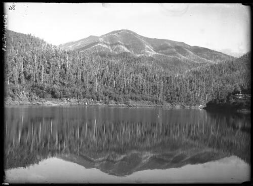 Kiewa, Victoria, bogong and Spion Kop reflected in Guy Lake, 1 [December 1947] [picture] : [State Electricity Commission of Victoria] / [Frank Hurley]