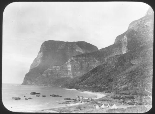[Four tents on a beach near high rocky cliffs] [picture] : [Lord Howe Island] / [Frank Hurley]