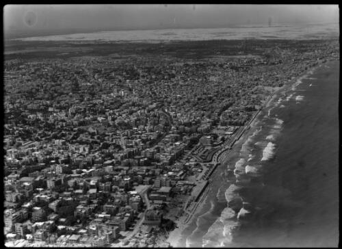 Tel Aviv aerial [showing buildings and a beach with surf] [picture] / [Frank Hurley]