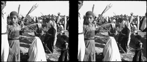 Village fair Esdud Palestine [boy wearing cap in the foreground] [picture] / [Frank Hurley]