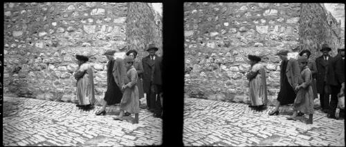 Orthodox Jews Jerusalem [walking next to a stone wall on a cobbled road] [picture] / [Frank Hurley]