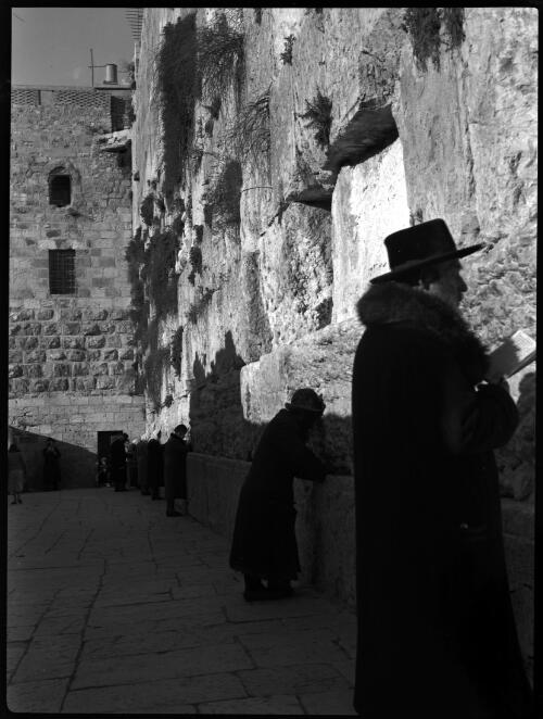The Wailing Wall [with figures, one in overcoat and hat, Jerusalem] [picture] / [Frank Hurley]