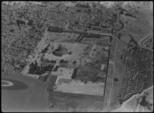 Site of the Temple, aerial, Jerusalem [the walled area of Temple Mount and Haram esh Sharif, with part of aircraft wing] [picture] / [Frank Hurley]