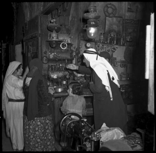 Shop, Jerusalem [interior with figures including a child] [picture] / [Frank Hurley]